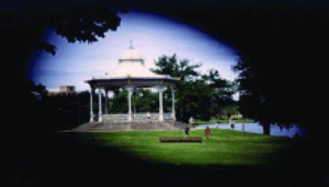 Image of a bandstand in a park with edges blacked out to simulate Peripheral vision loss